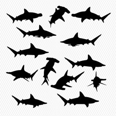 A collection of black shark silhouettes, including hammerhead species, swimming in various poses.