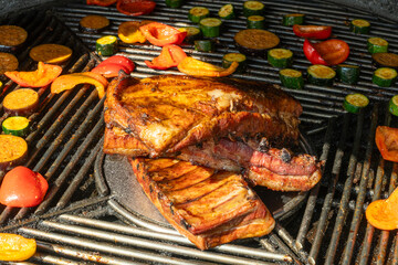 Grilled Pork Ribs And Vegetables On Barbecue. Summer Barbecue Scene With Juicy Pork Ribs And...