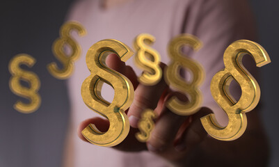 Abstract image of golden paragraph symbols floating near a hand, ideal for legal or law concepts.