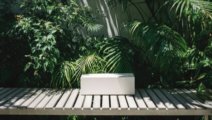 White box on a wooden patio amongst lush greenery