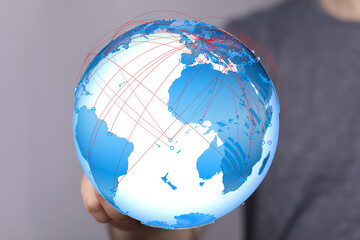 Image of a hand holding a digital globe, illustrating global connectivity and communication.