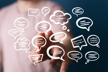 Hand interacting with floating speech bubbles,communication, dialogue, social media concept.