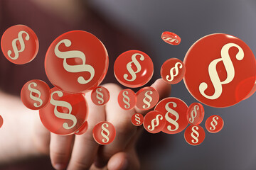 Abstract image of paragraph symbols floating around a hand, representing legal concepts, law, and...