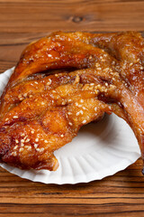 angle view honey-glazed roast duck leg at vertical composition