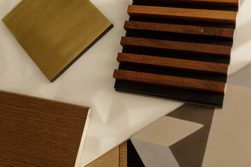 High-quality image of various wood, brass, and tile samples for interior design projects.