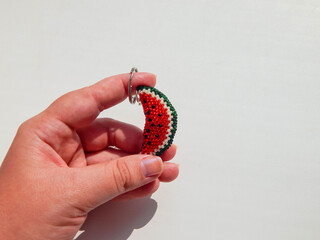 Colorful keychain lies on a woman's palm