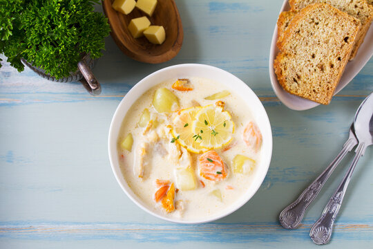 Thick soup chowder made with salmon, white fish, shrimps and vegetables. High angle view