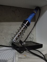 An electric soldering rod stored in its place