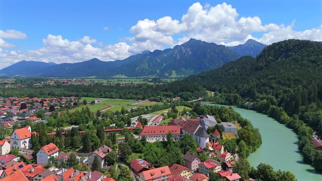 Aerial video of small village in Bavaria with Lech river and rolling alpine hills 