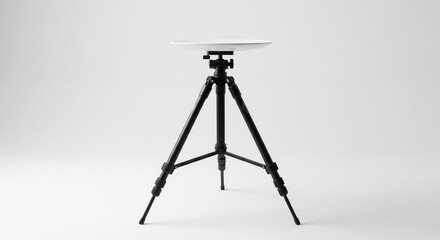 A camera stand holding a plate-like object at its top isolated on white