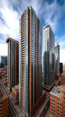 Modern skyscrapers dominate urban skyline, showcasing sleek designs and glass facades. bustling city below reflects vibrant atmosphere