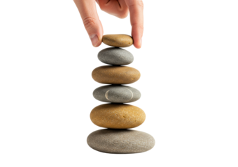 Balanced stack of river stones with hand on top creating harmony and balance. Cut out PNG