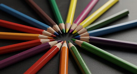 Fototapeta premium Circular arrangement of vibrant coloring pencils converge to form a colorful central focal point.