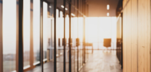 Bright modern office space with glass walls and wooden accents, combining sleek architectural elements with natural textures to create a warm professional workspace.