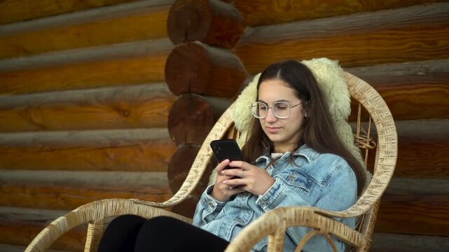young woman enjoying relaxing with her smartphone