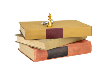 Strategy and knowledge for success concept with chess king on books, isolated on white background with clipping path.