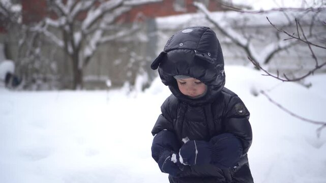 a child joyfully playing in a snowy winter wonderl