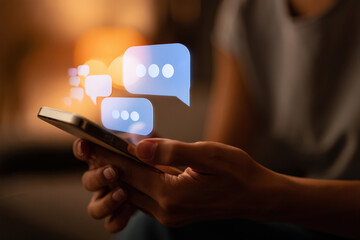 Digital Dialogue Connecting Through Technology A Close-Up of Hands Using a Smartphone with Chat Bubbles Illustrating Communication and Social Interaction in the Modern Era