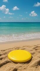 Yellow frisbee on sandy beach.