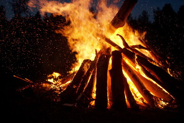 A large bonfire burns on Midsummer Eve in Latvia.
Bright bonfire flame on the rural field at evening