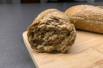 Closeup image of freshly baked wholemeal bread on a wooden chopping board