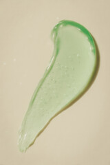 Green aloe vera gel smear on beige surface, AI generated