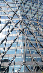 Modern architecture building facade abstract pattern. Closeup of steel exoskeleton structure on corporate glass office window in london city.