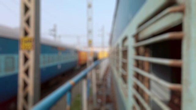 Bokeh view of passenger suburban train arriving at Tirupati railway station in Tirupati, India. Blurred background footage.