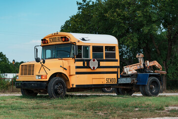 Yellow school bus modified to be a tow truck in a small town in Texas, USA