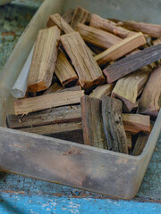 A container filled with small pieces of wood, possibly for burning as incense or aromatherapy.