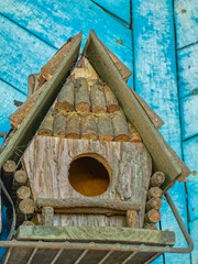 A charming, handmade birdhouse provides a welcoming shelter for feathered friends.