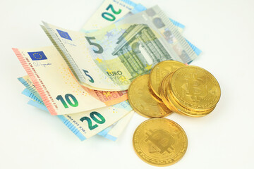 Bitcoins and Euro bills on white background