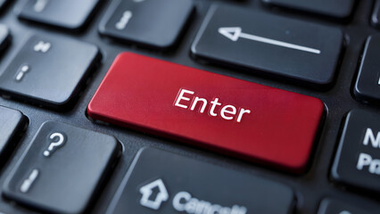 A close up of a keyboard with a red enter key surrounded by other black keys on a dark surface
