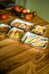 Healthy ready meals in eco and plastic containers: salads, soups, rice bowls, sandwiches and...