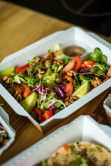 Healthy ready meals in eco and plastic containers: salads, soups, rice bowls, sandwiches and...