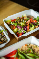 Healthy ready meals in eco and plastic containers: salads, soups, rice bowls, sandwiches and...