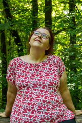 Thoughtful woman with red-brown hair and glasses