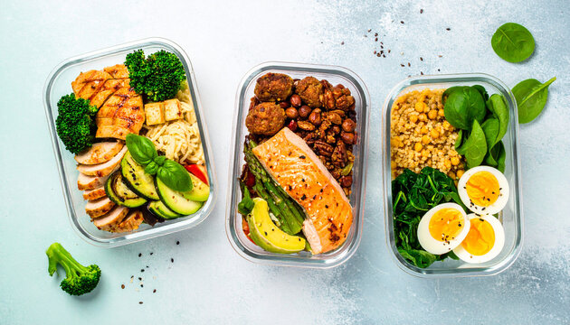 A variety of healthy meal prep containers with nutritious food like grilled chicken, salmon, and vegetables for a balanced weekly diet.