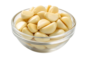 Peeled garlic cloves in glass bowl on transparent background