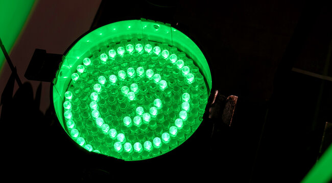 Green LED stage par light viewed from above with circular spiral array of glowing diodes, professional lighting fixture, venue equipment closeup, concert, theatre event production copy space