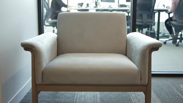 Contemporary upholstered armchair designed for comfort, an inviting and elegant seating solution in a modern office waiting area or common space.
