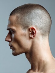 Obraz premium Profile View of a Buzz Cut Hairstyle Showcasing Gradient Light Against an Empty Background Highlighting Facial Features and Hairstyle Contours