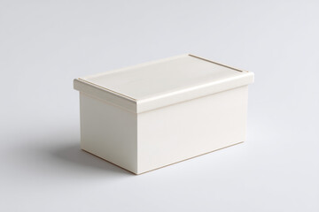 A simple ivory storage box is sitting on a white surface. The box appears to be made of wood or a wood-like material.