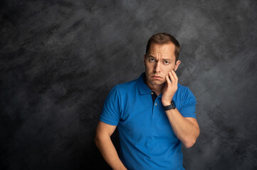 Man Touching His Cheek with a Pained Expression