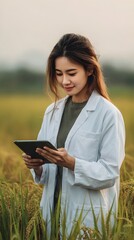 A woman in a white lab coat is looking at a tablet