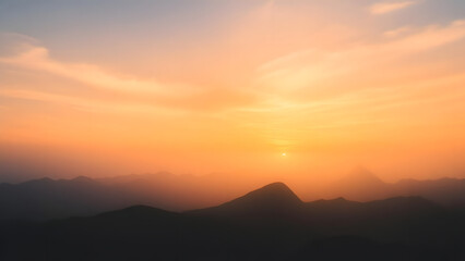 Obraz premium Scenic Mountain Landscape at Sunset with Warm Sky and Silhouetted Peaks