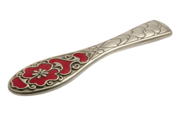Ornate silver spoon with red floral enamel isolated on a transparent background antique