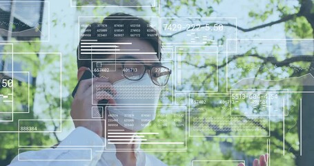 Masked businessman raising smartphone and monitoring business data panels animating into dashboard - Powered by Adobe