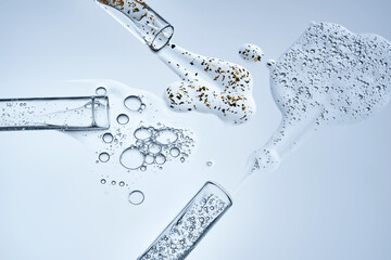 Three test tubes with spilled serums. Demonstration of textures.