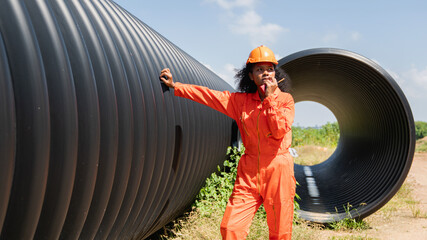 Engineers collaborate inside a massive steel pipe, constructing a tunnel for an industrial pipeline...